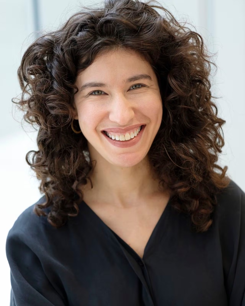 Headshot of Emily Liebert, looking directly into the camera. She is wearing a dark blouse.